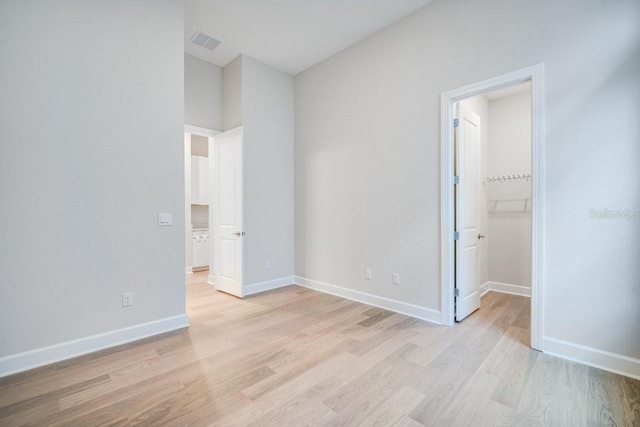 unfurnished bedroom featuring light wood-type flooring, visible vents, and baseboards