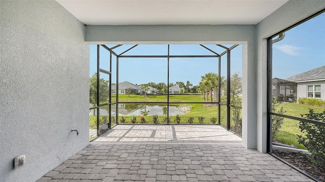 unfurnished sunroom with a water view