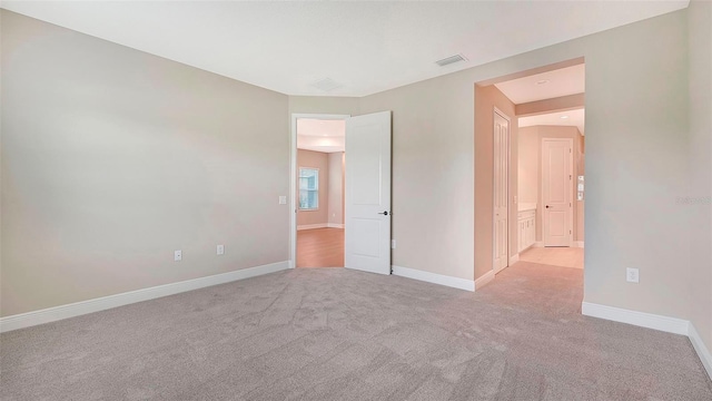 empty room featuring light carpet