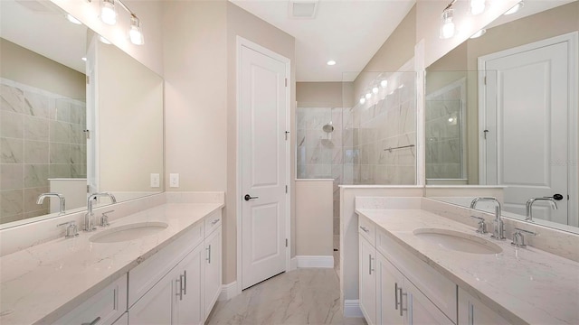 bathroom featuring vanity and tiled shower