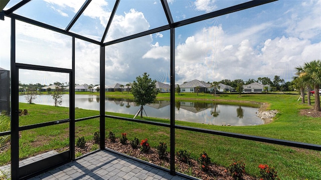 unfurnished sunroom with a water view and a wealth of natural light