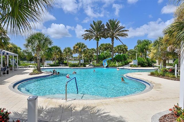 view of pool with a patio area and a water slide