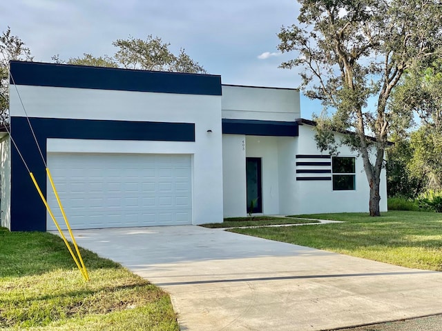 modern home featuring a garage and a front lawn