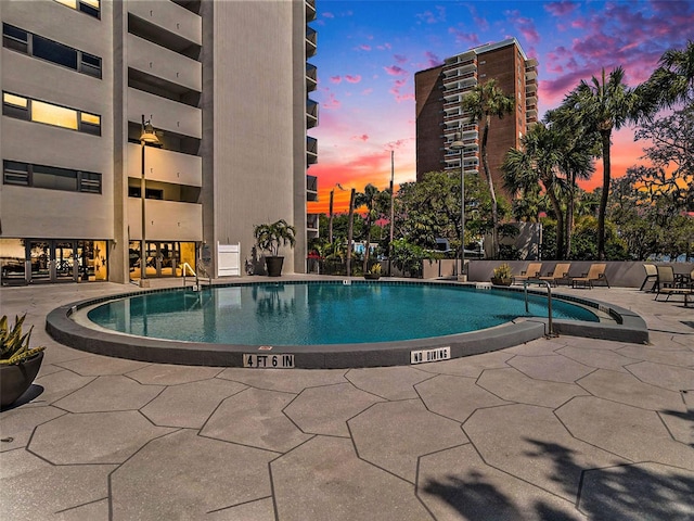 view of pool at dusk