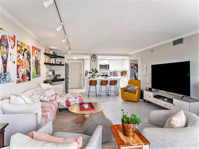 tiled living room featuring track lighting, a textured ceiling, and crown molding