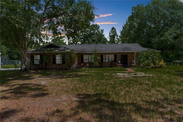 ranch-style house featuring a lawn