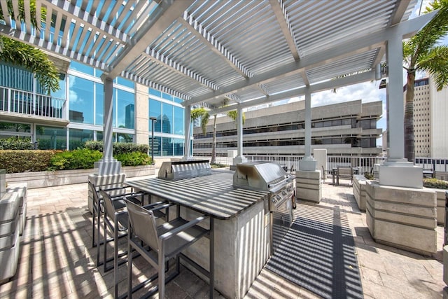 view of patio / terrace with a pergola, area for grilling, and exterior kitchen