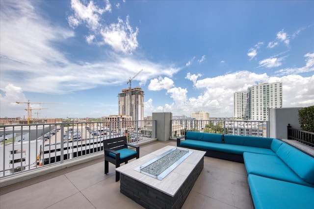 view of patio featuring an outdoor living space with a fire pit