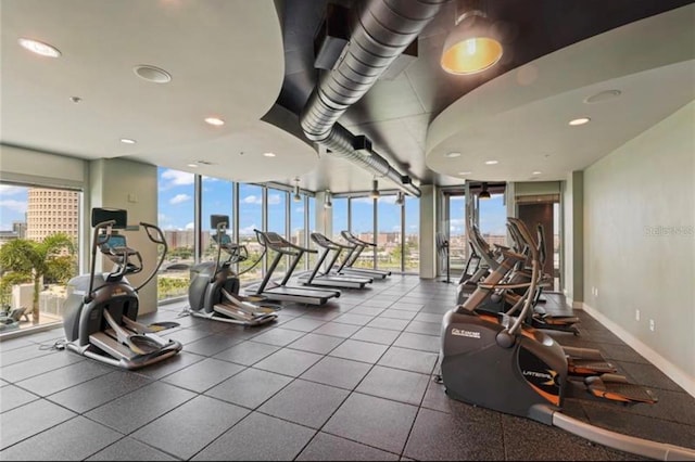 workout area featuring expansive windows and a healthy amount of sunlight