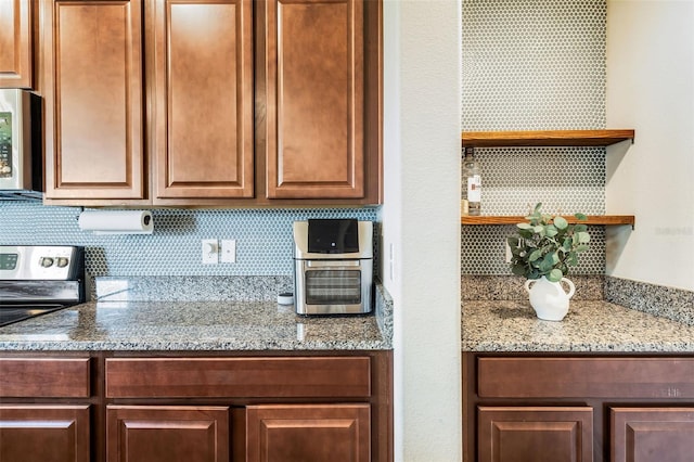 kitchen with stainless steel range with electric cooktop and tasteful backsplash