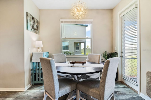 dining area featuring dark hardwood / wood-style floors and an inviting chandelier