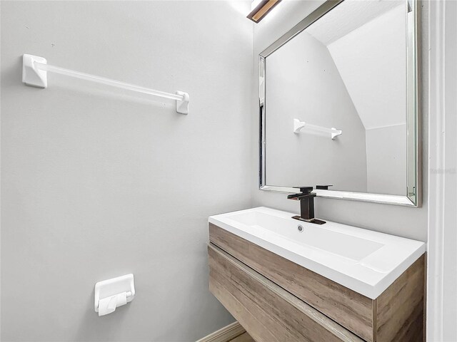 bathroom with vanity and vaulted ceiling