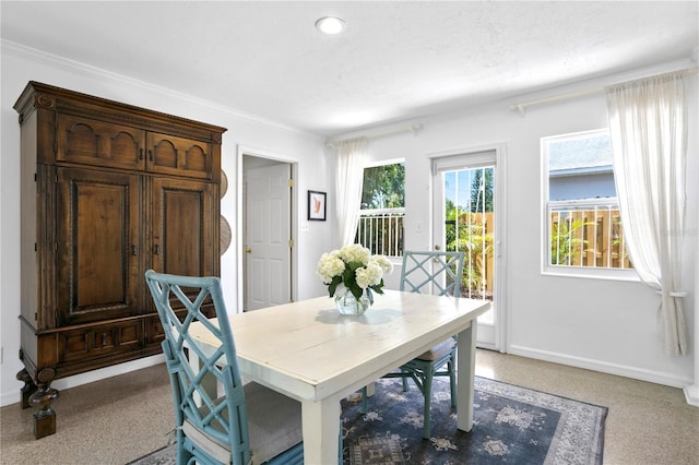 dining space featuring crown molding