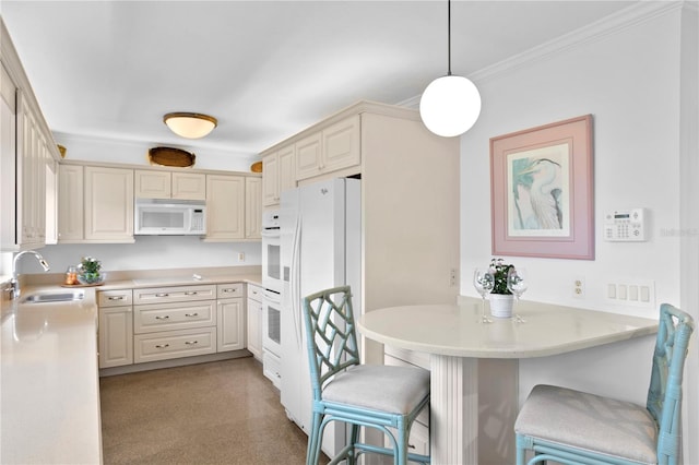 kitchen featuring sink, a kitchen breakfast bar, kitchen peninsula, decorative light fixtures, and white appliances