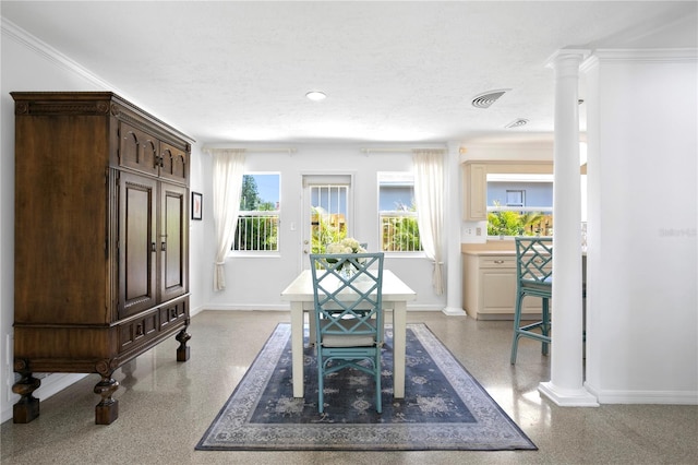 dining space with a textured ceiling and ornamental molding