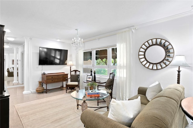 living room with ornate columns, crown molding, and an inviting chandelier