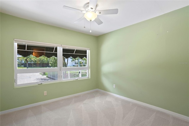 empty room featuring carpet floors and ceiling fan