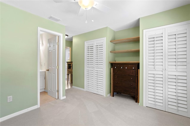 unfurnished bedroom with connected bathroom, ceiling fan, and light colored carpet