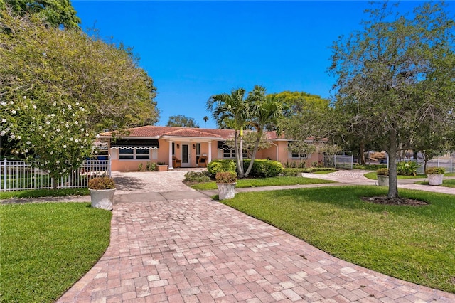 mediterranean / spanish-style house featuring a front lawn