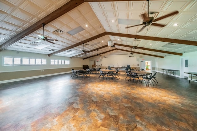 unfurnished dining area featuring visible vents, ceiling fan, lofted ceiling with beams, and baseboards