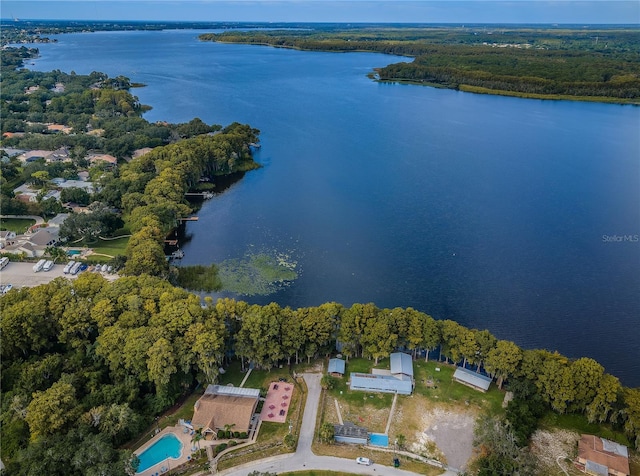 drone / aerial view with a water view and a forest view