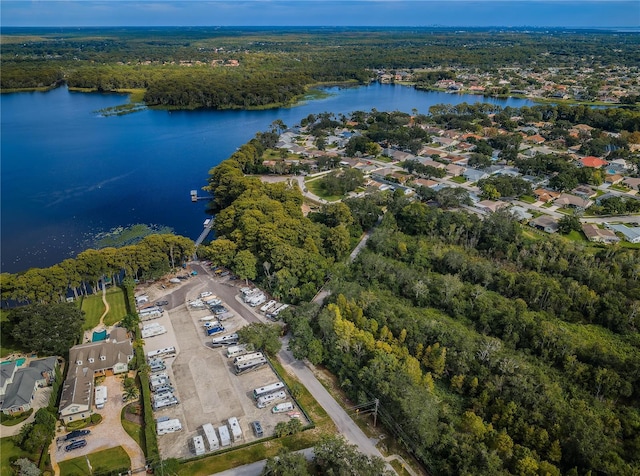 aerial view with a water view and a forest view