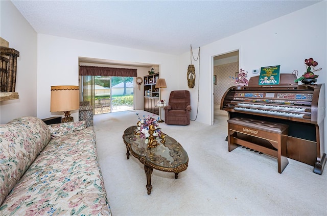 living area featuring light carpet and a textured ceiling