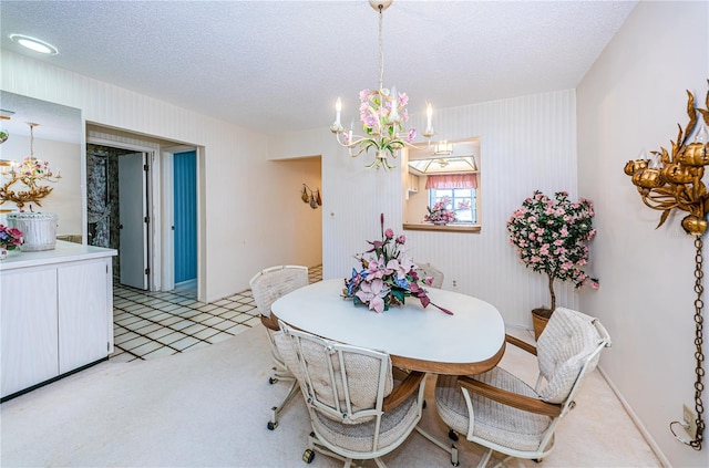 dining area featuring an inviting chandelier, a textured ceiling, and light colored carpet