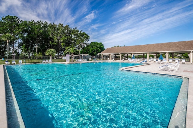 community pool featuring a patio area and fence