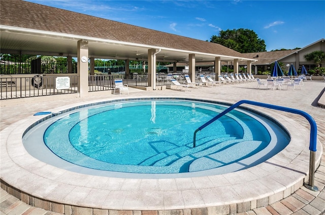 view of swimming pool with fence and a patio