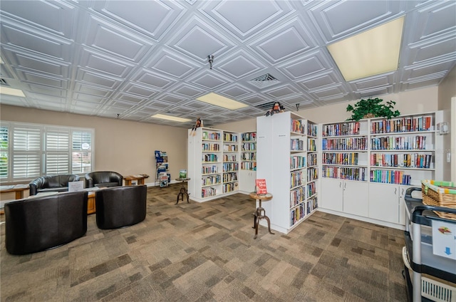 office area with an ornate ceiling, bookshelves, and carpet floors