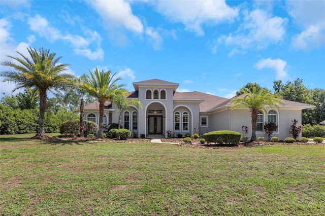 mediterranean / spanish-style house with french doors and a front yard