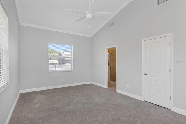 carpeted empty room featuring ceiling fan, high vaulted ceiling, and ornamental molding