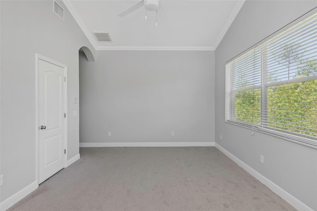 carpeted empty room with ceiling fan and ornamental molding