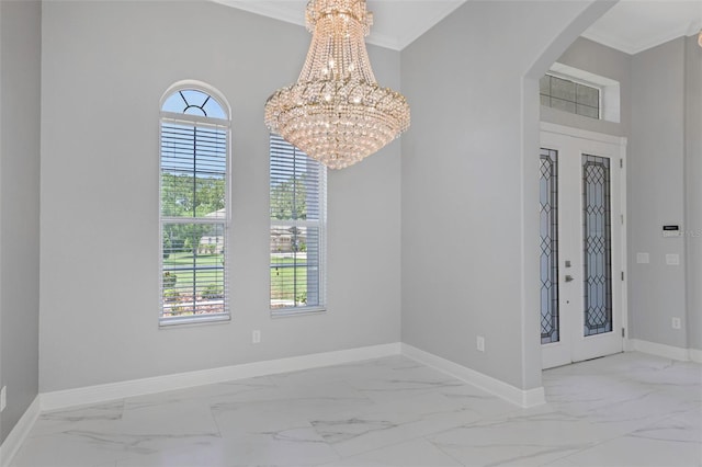 unfurnished room with a notable chandelier and ornamental molding