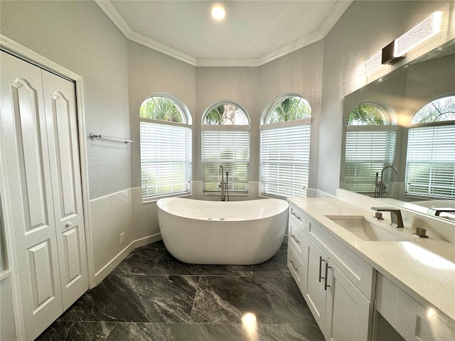 bathroom with vanity, a tub to relax in, plenty of natural light, and ornamental molding