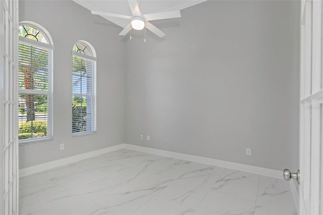 spare room featuring ceiling fan and plenty of natural light