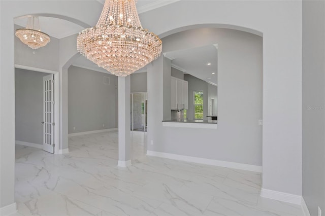 unfurnished dining area featuring a notable chandelier and crown molding