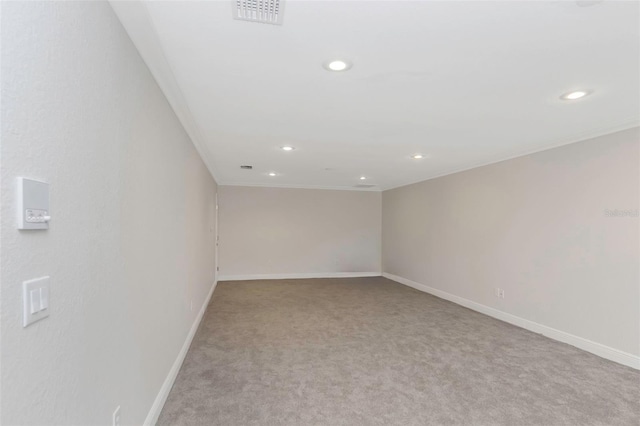 carpeted empty room featuring ornamental molding