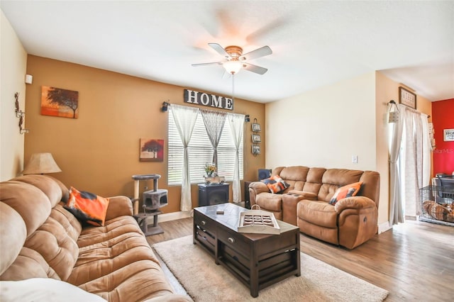 living room with light wood-type flooring and ceiling fan