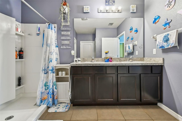 bathroom with curtained shower, tile patterned floors, and vanity