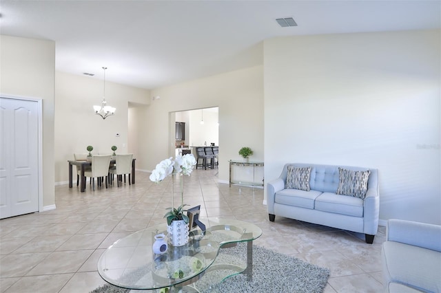 tiled living room featuring a high ceiling and a chandelier