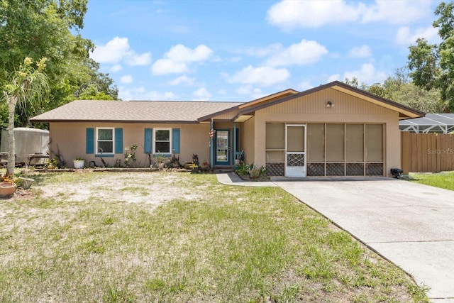 ranch-style house with a garage and a front lawn