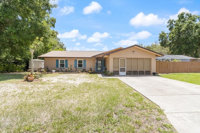 ranch-style house featuring a garage and a front yard