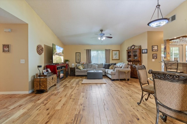 living room featuring light hardwood / wood-style floors, a healthy amount of sunlight, and ceiling fan