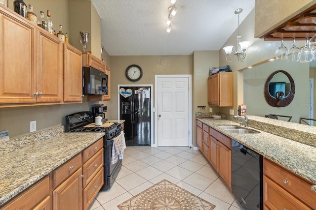 kitchen featuring light tile flooring, black appliances, track lighting, sink, and a textured ceiling