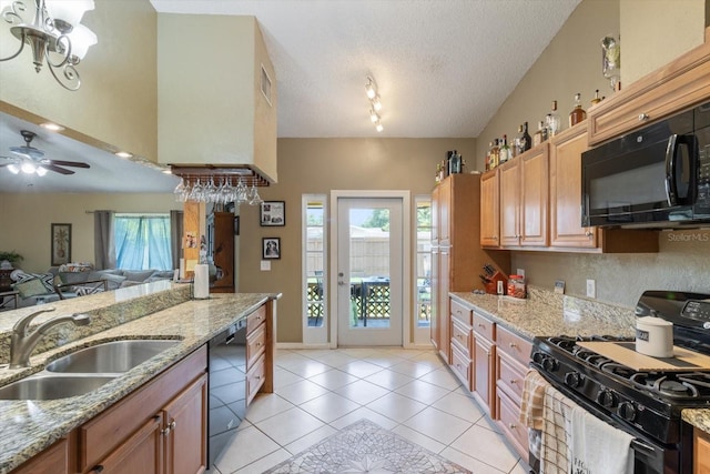 kitchen with ceiling fan with notable chandelier, black appliances, track lighting, sink, and a textured ceiling