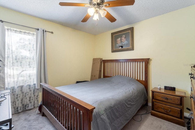 carpeted bedroom featuring a textured ceiling and ceiling fan