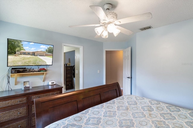 bedroom featuring a textured ceiling and ceiling fan