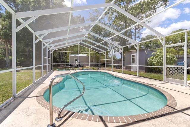 view of pool with a shed and glass enclosure